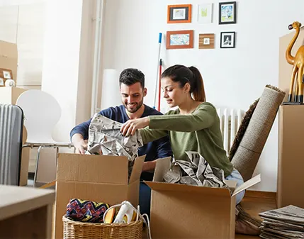 A couple unpacking moving boxes