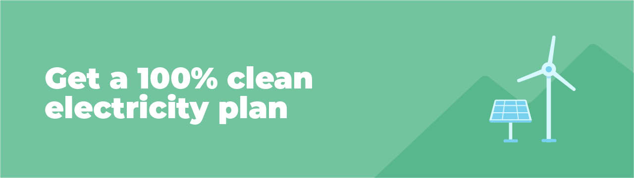 Solar panel and wind turbine in front of green mountains